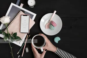 Smartphone & Woman Holding Coffee on Black Background