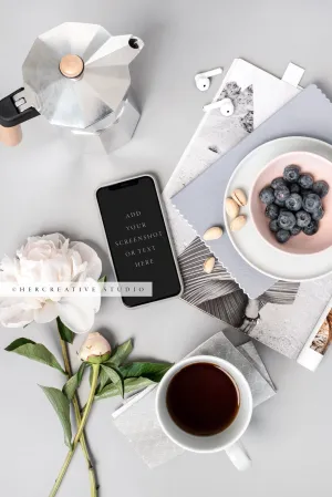 Smartphone, Blueberries and Peony on Grey Background. Stock Image
