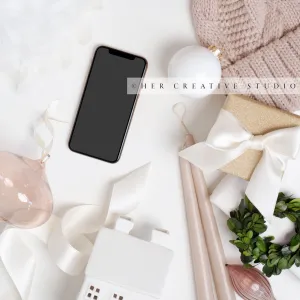 Smartphone with Holiday Gift & Hat on White Background