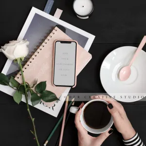 Woman Holding Coffee with Smartphone on Black Desk